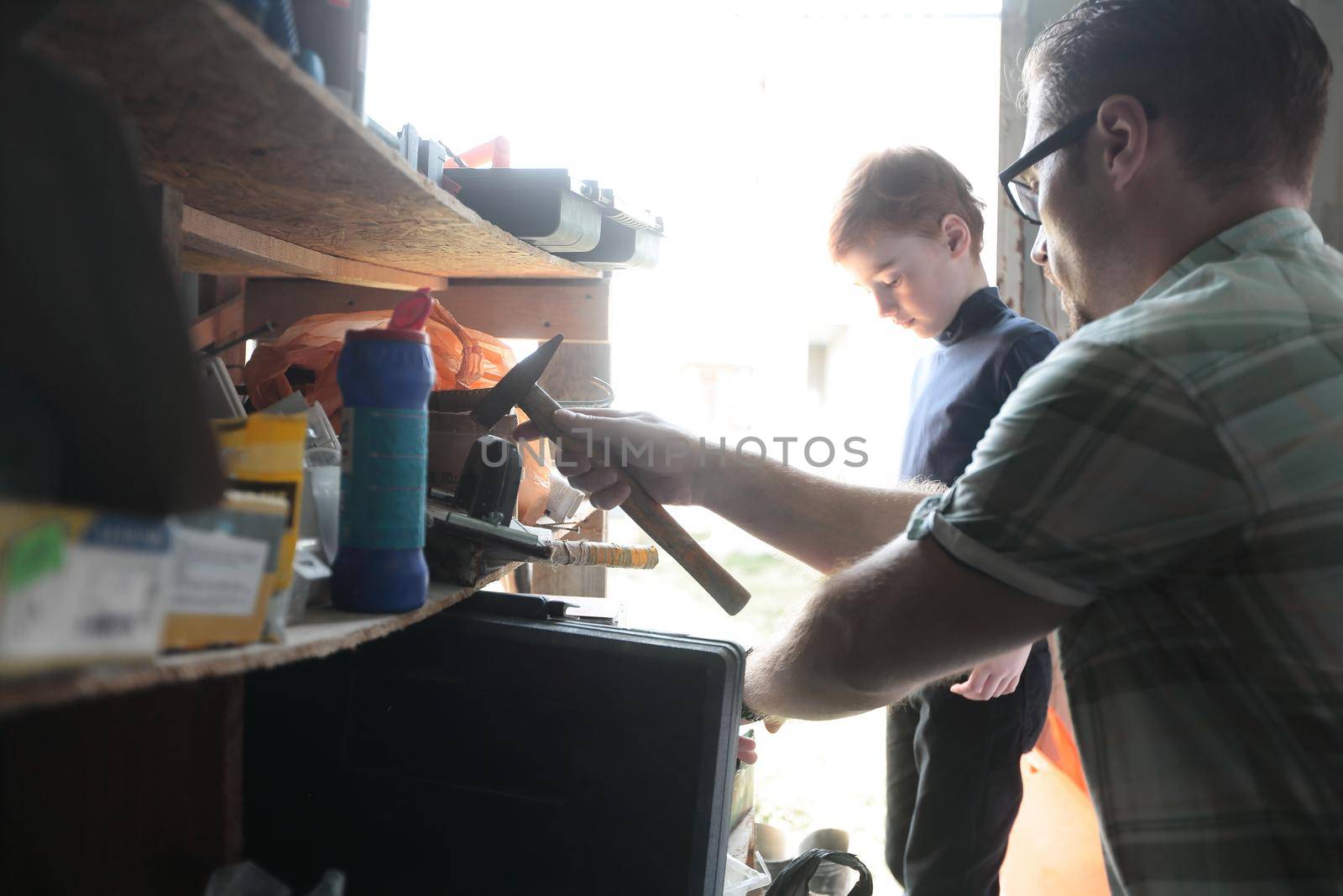 father and his little son work together in the garage.the concept of learning in the family