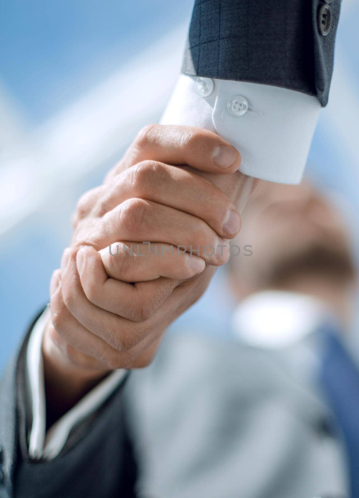 close up.handshake of business people on a light background.business concept