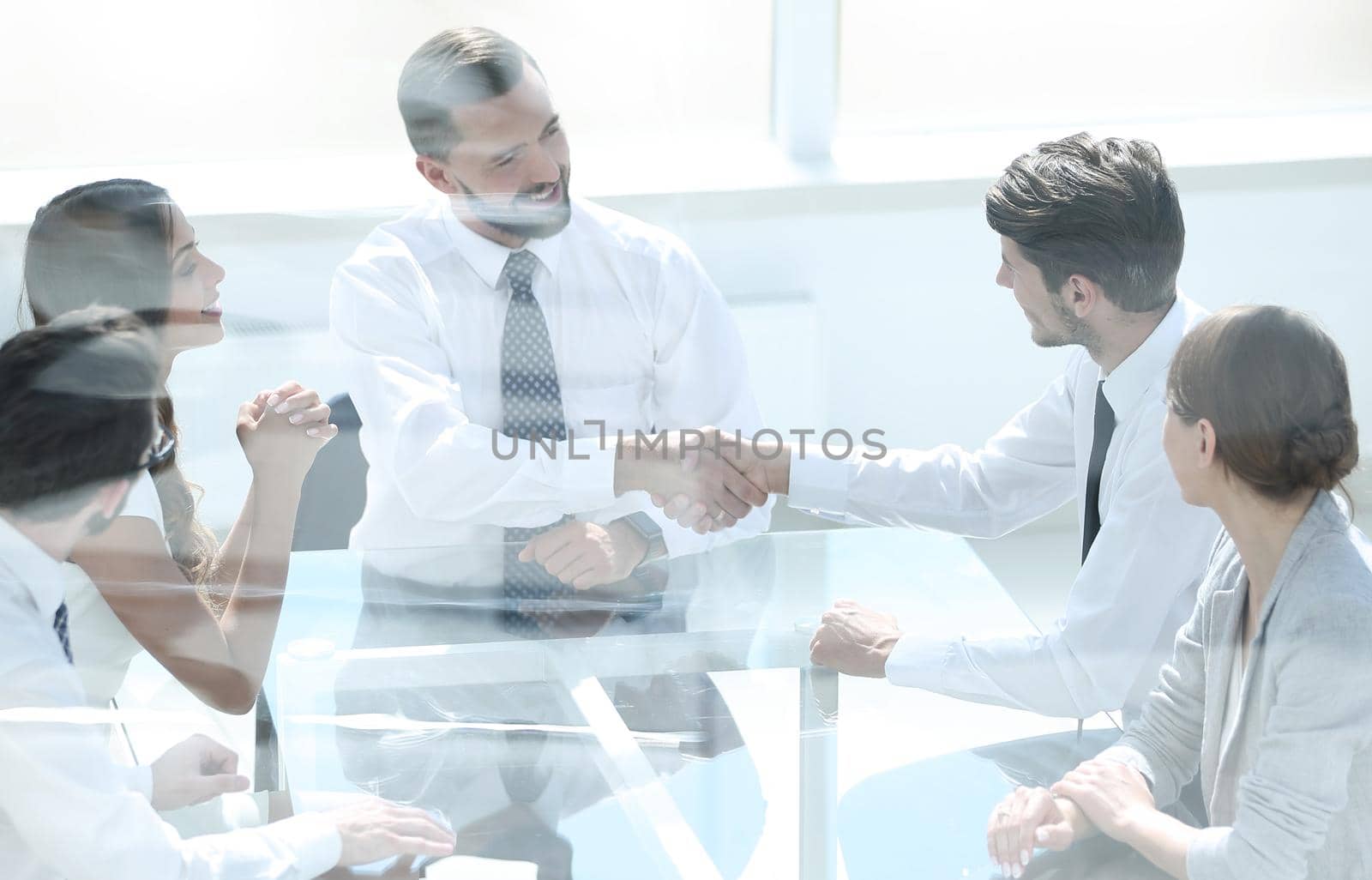 handshake employees at a meeting in the office by asdf