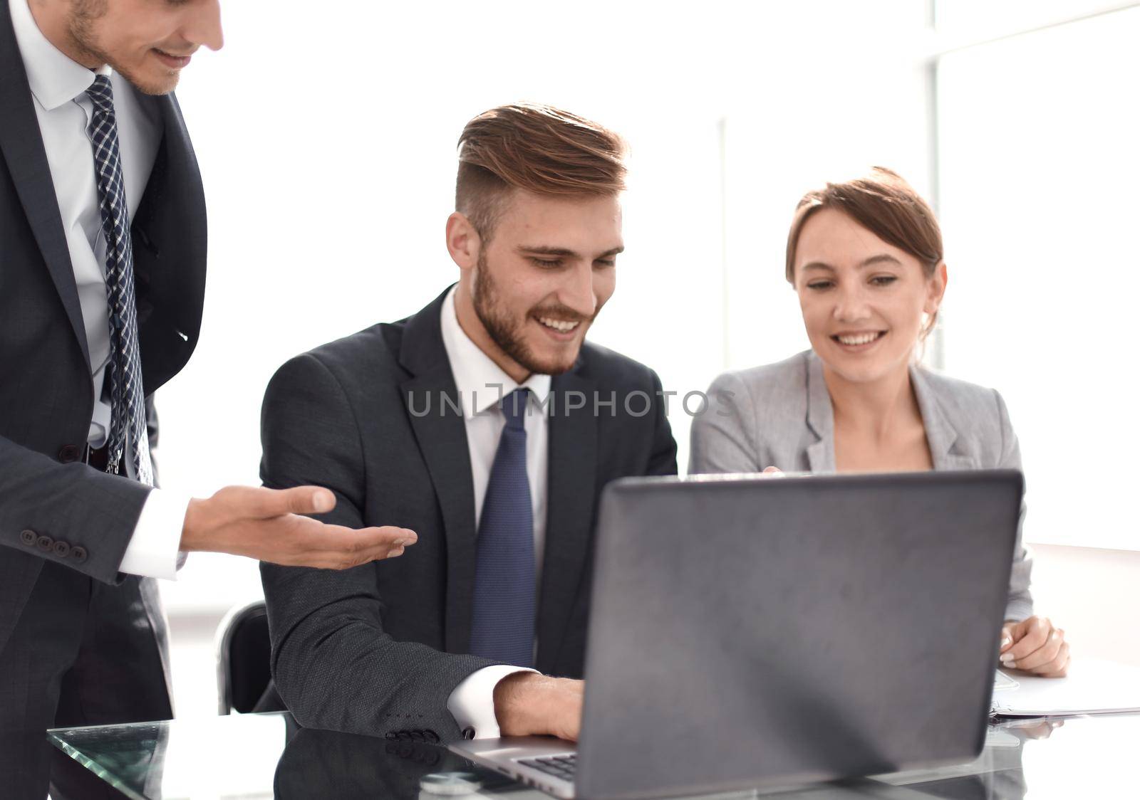 smiling business team discussing online news by asdf