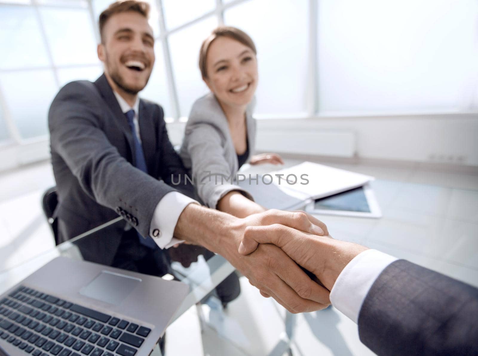 smiling business partners greeting each other .concept of partnership
