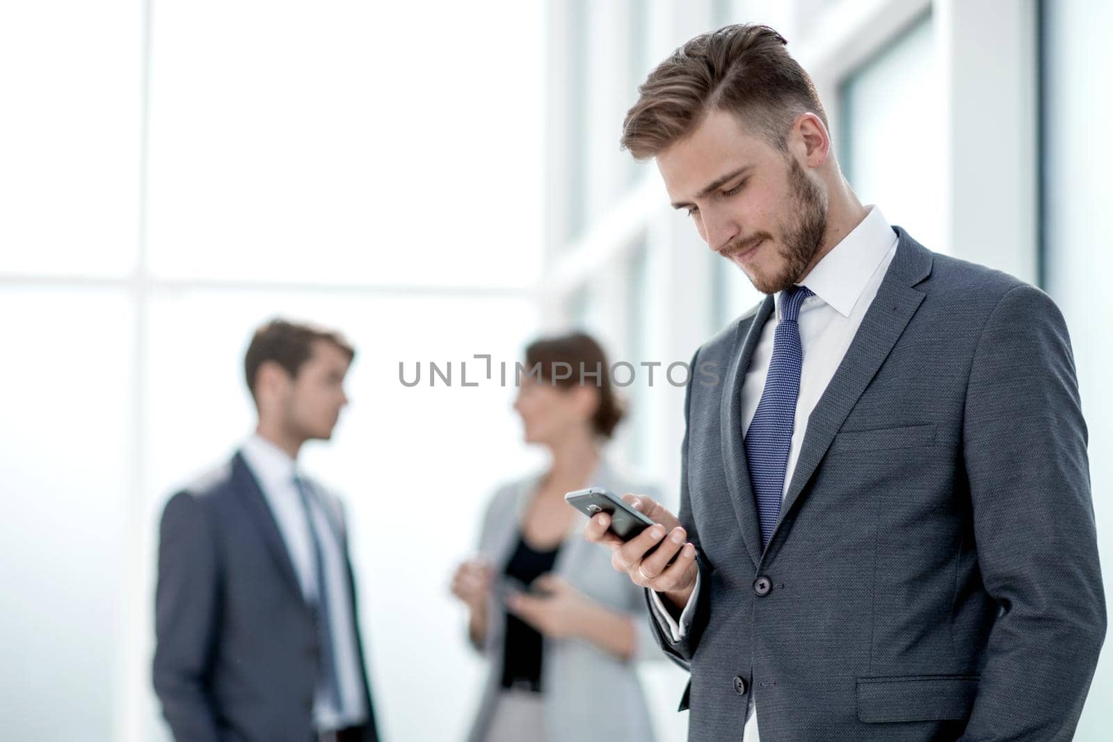 serious businessman looking at the screen of his smartphone.photo with space for text