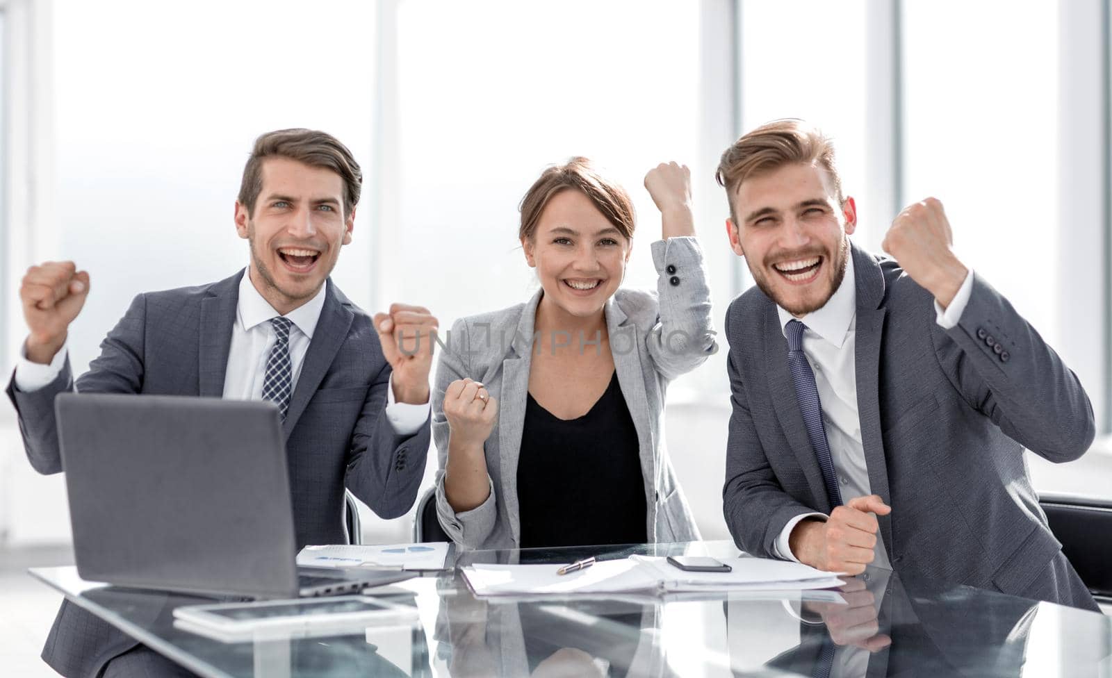 happy business team sitting at the Desk.photo with copy space