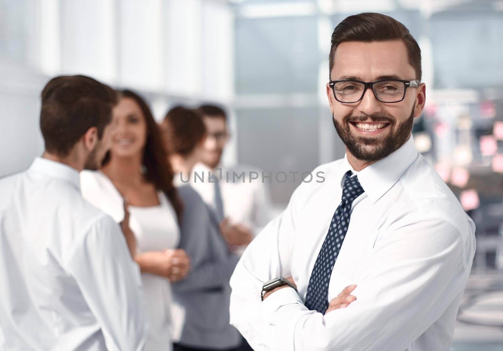 portrait of a successful businessman on the background of the office . business people