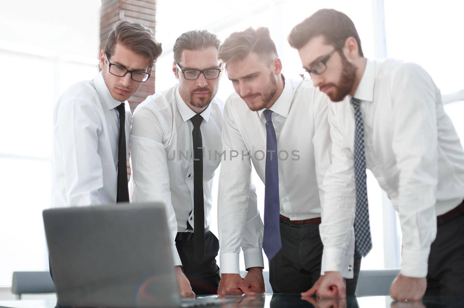 close up.a group of employees looking at the laptop screen.people and technology