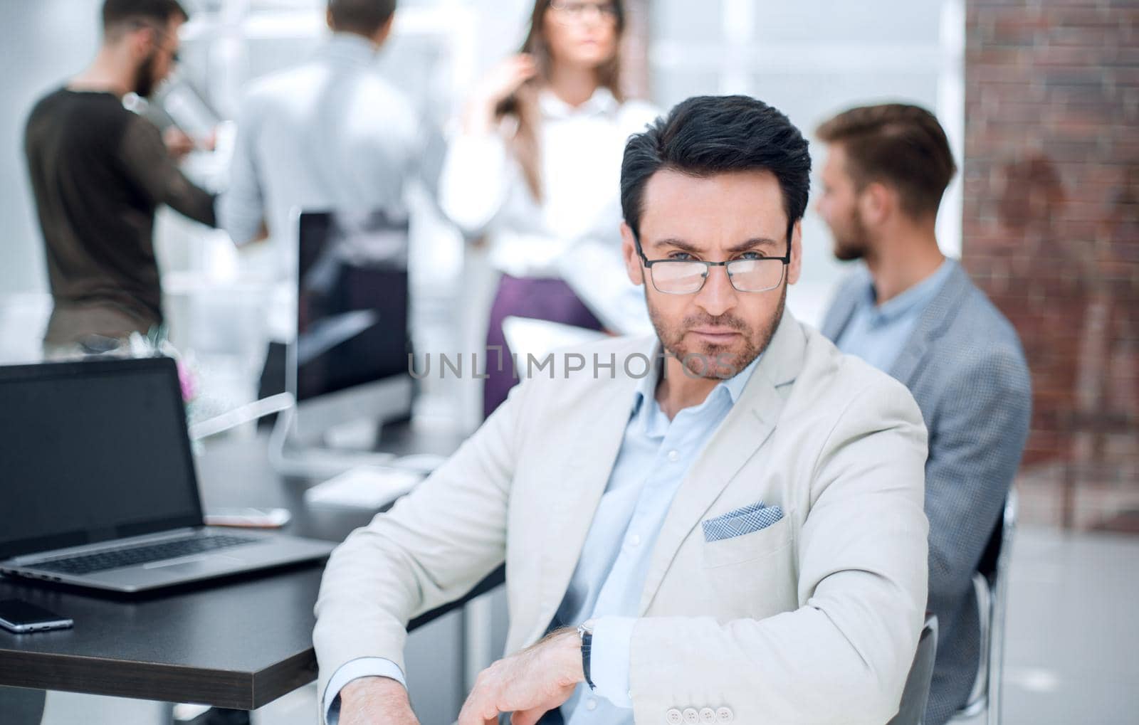 businessman sitting at his Desk on the background of the office.business people