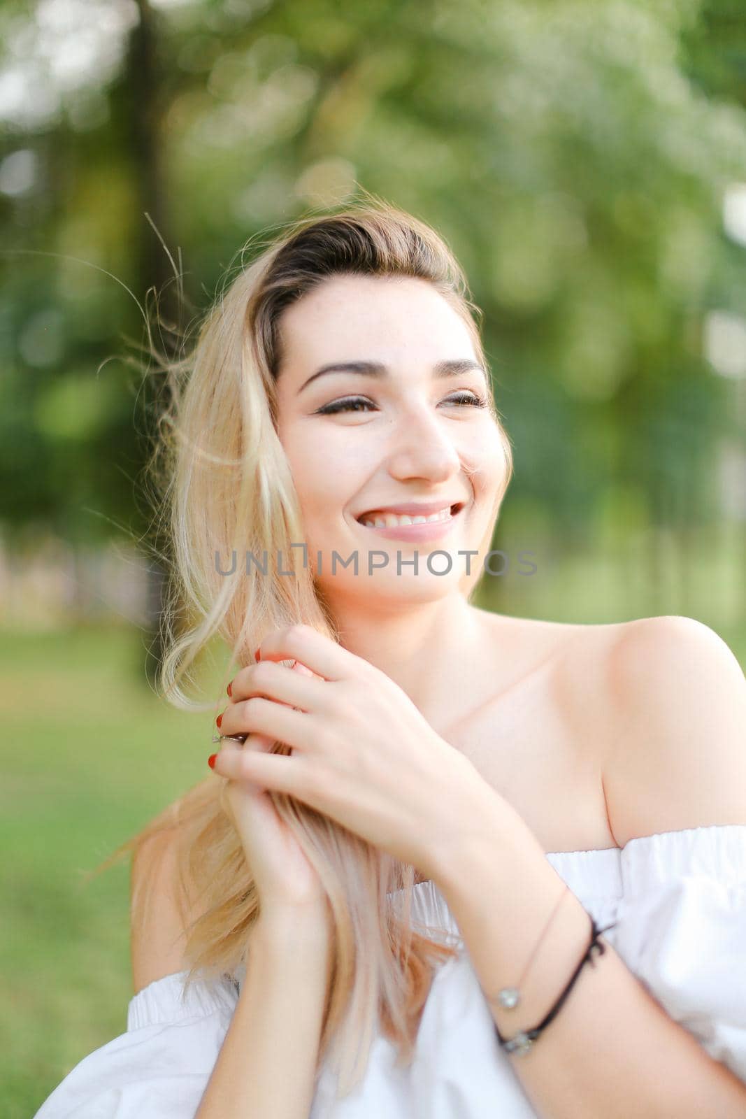 Portrait of young happy girl, green background. Concept of beauty and everyday makeup.