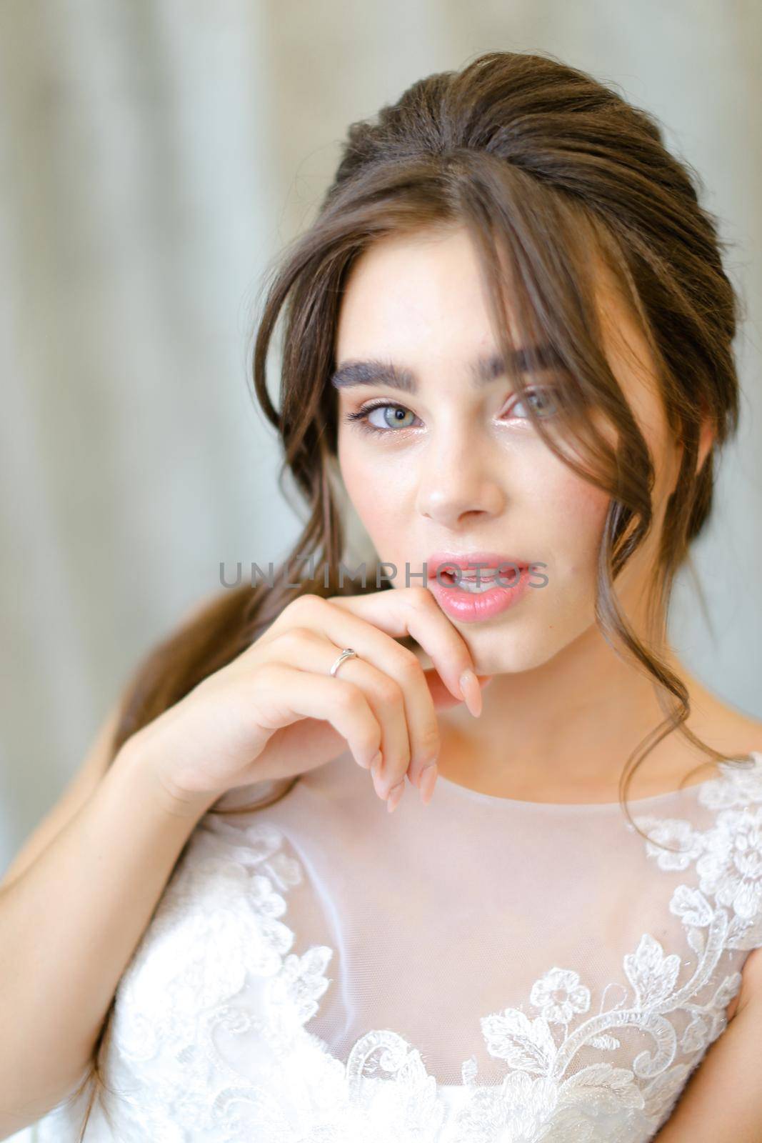 Close up portrait of young caucasian brunette bride at photo studio. by sisterspro