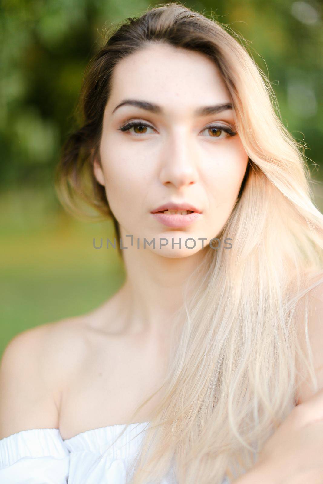 Portrait of young gorgeous girl, green background. Concept of beauty and everyday makeup.