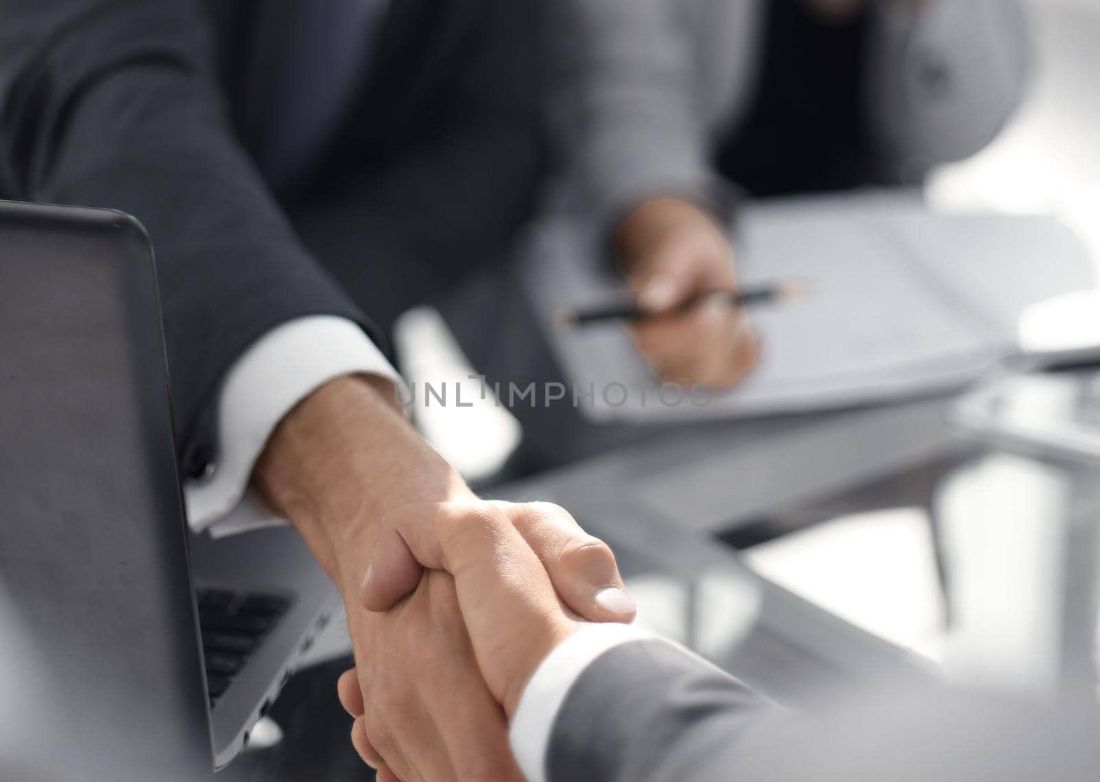 background image of business handshake over the Desk.business background