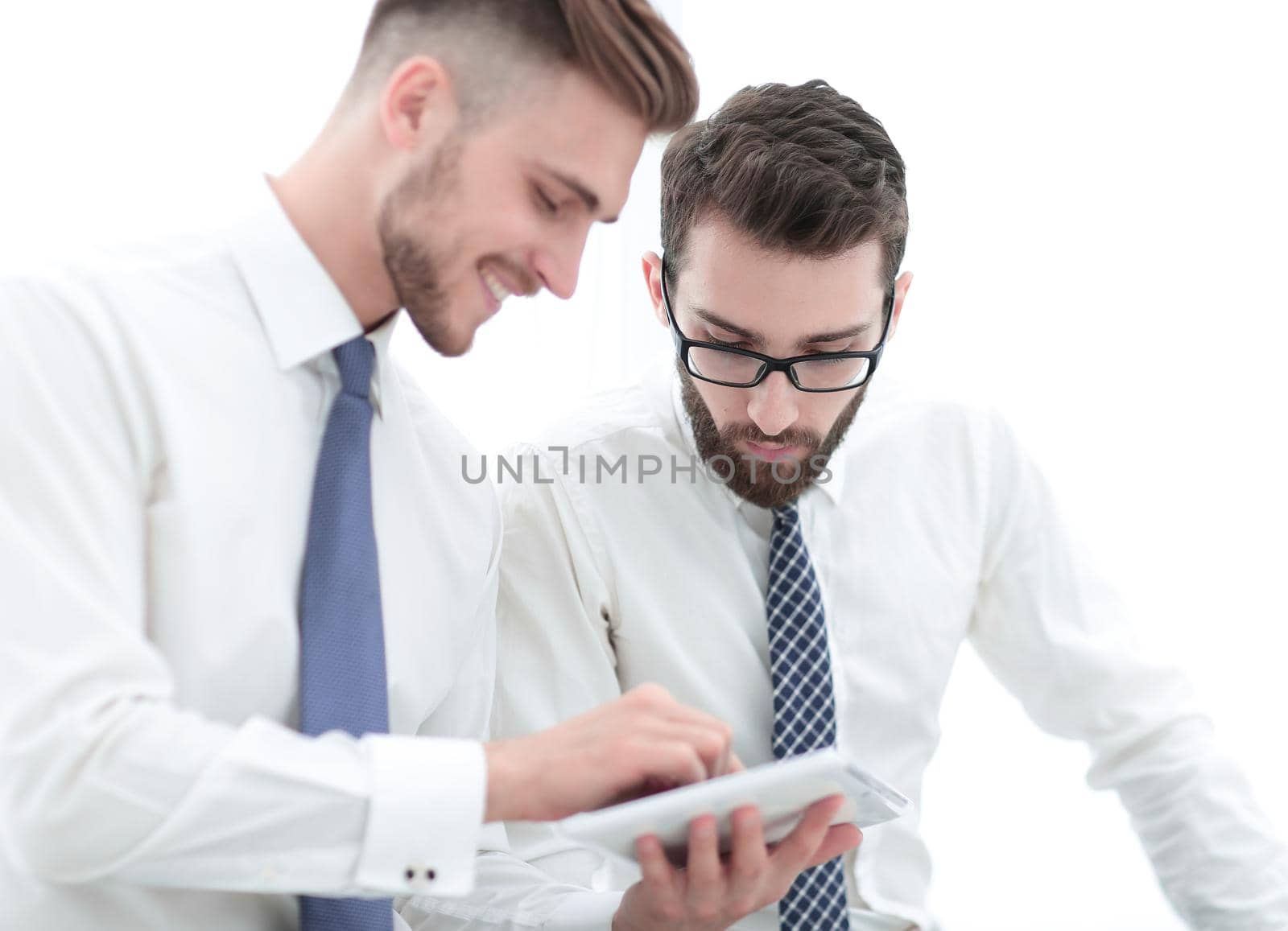 close up.two employees looking at the digital tablet screen.people and technology