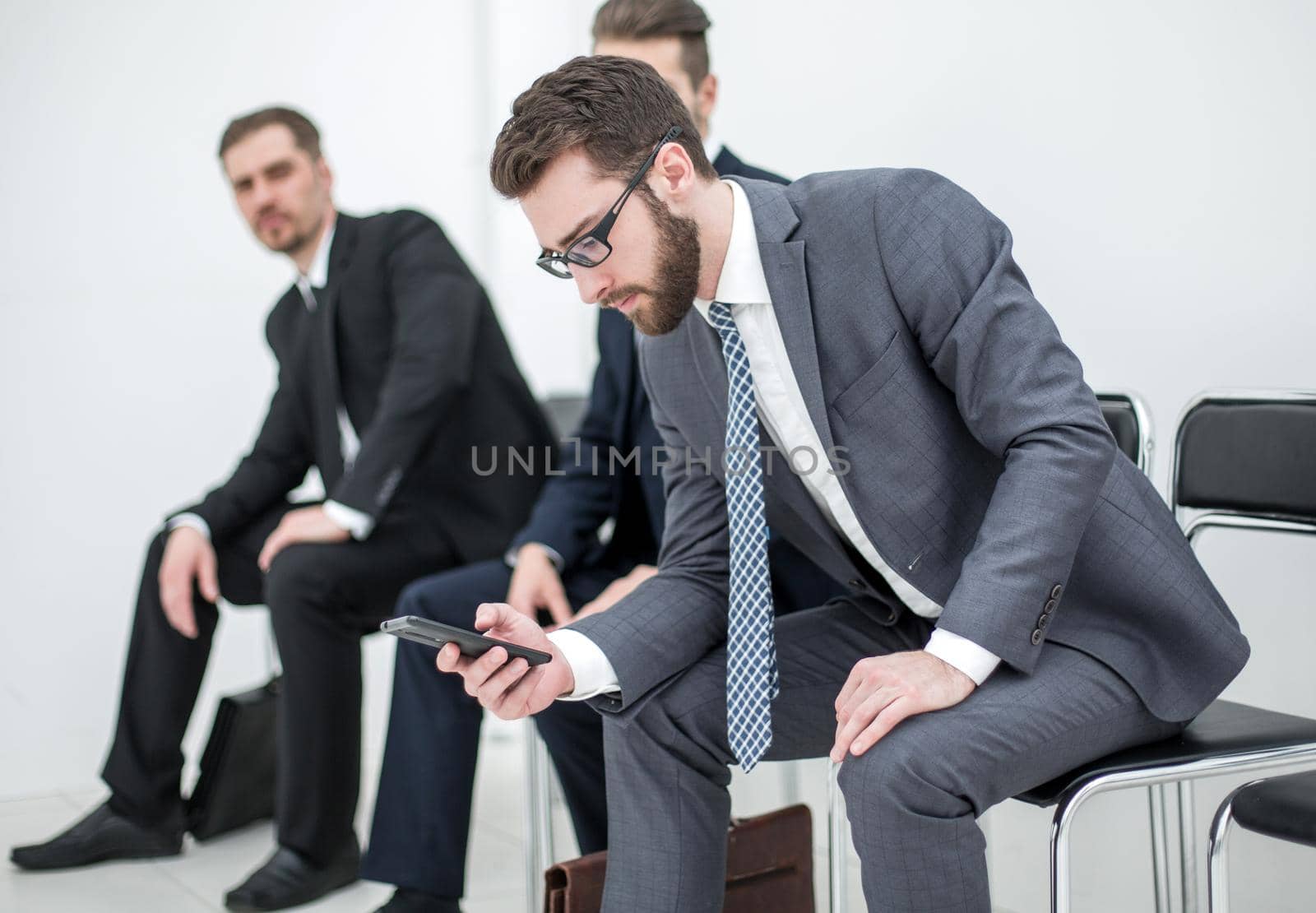 group of business people waiting for a meeting sitting in the office reception.photo with text space