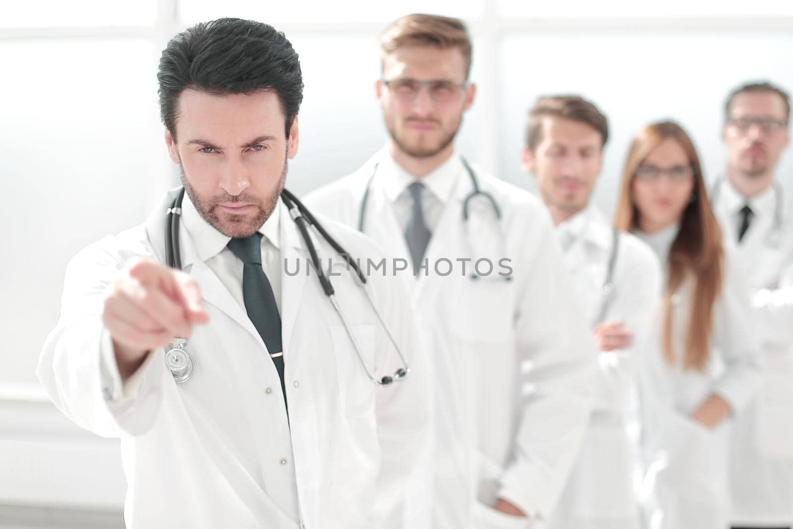 strict doctor, pointing at you, standing in the workplace. health care concept.