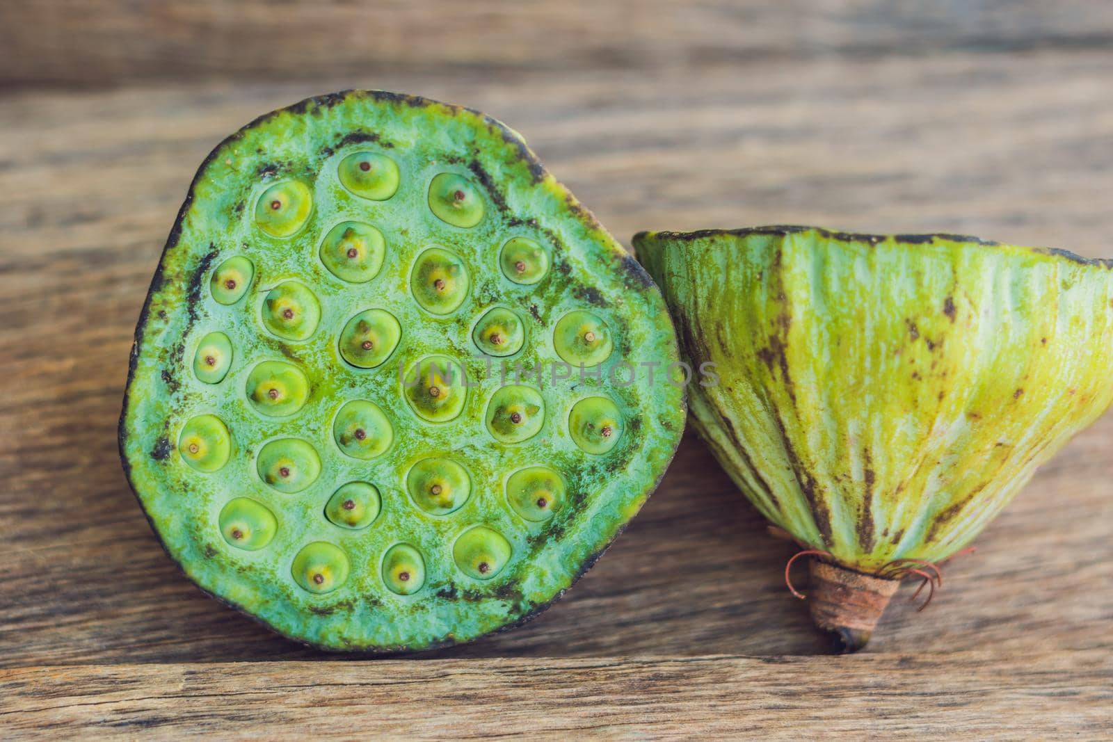 Lotus seeds on an old wooden background by galitskaya