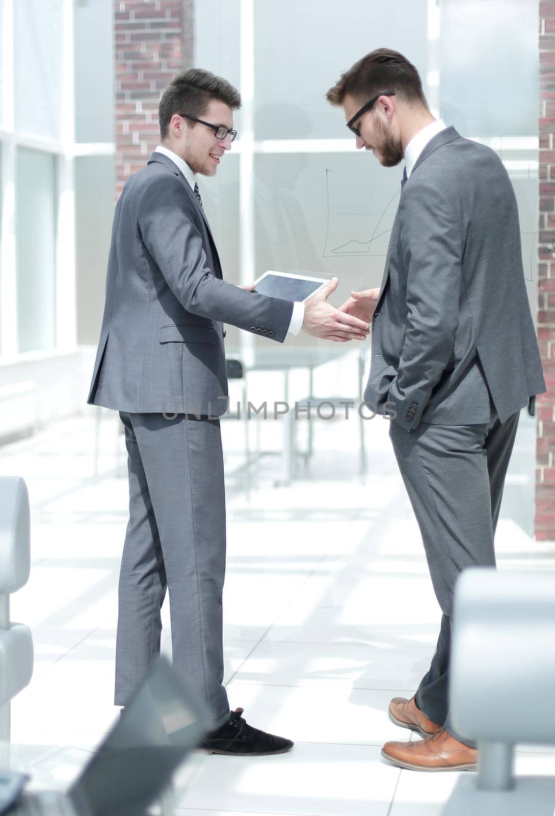 handshake two employees standing in the office . business concept