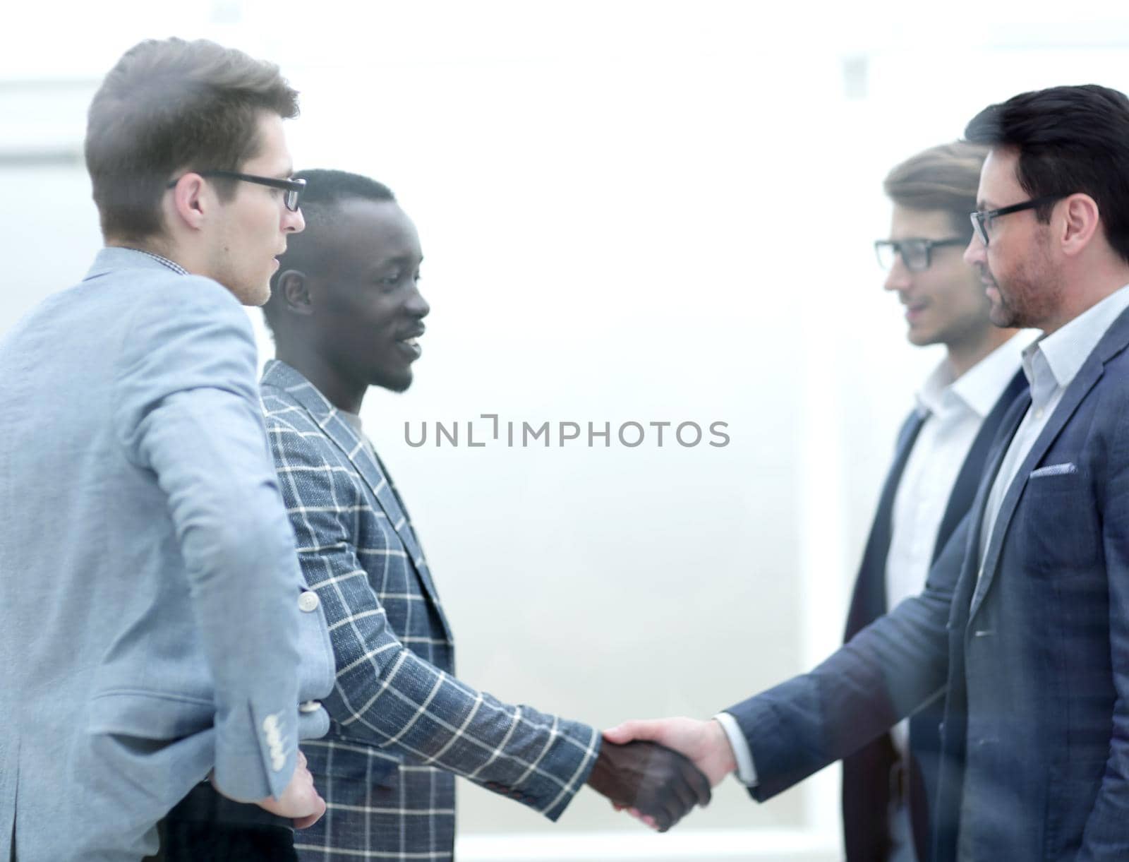 handshake of international business partners at the meeting in the office.