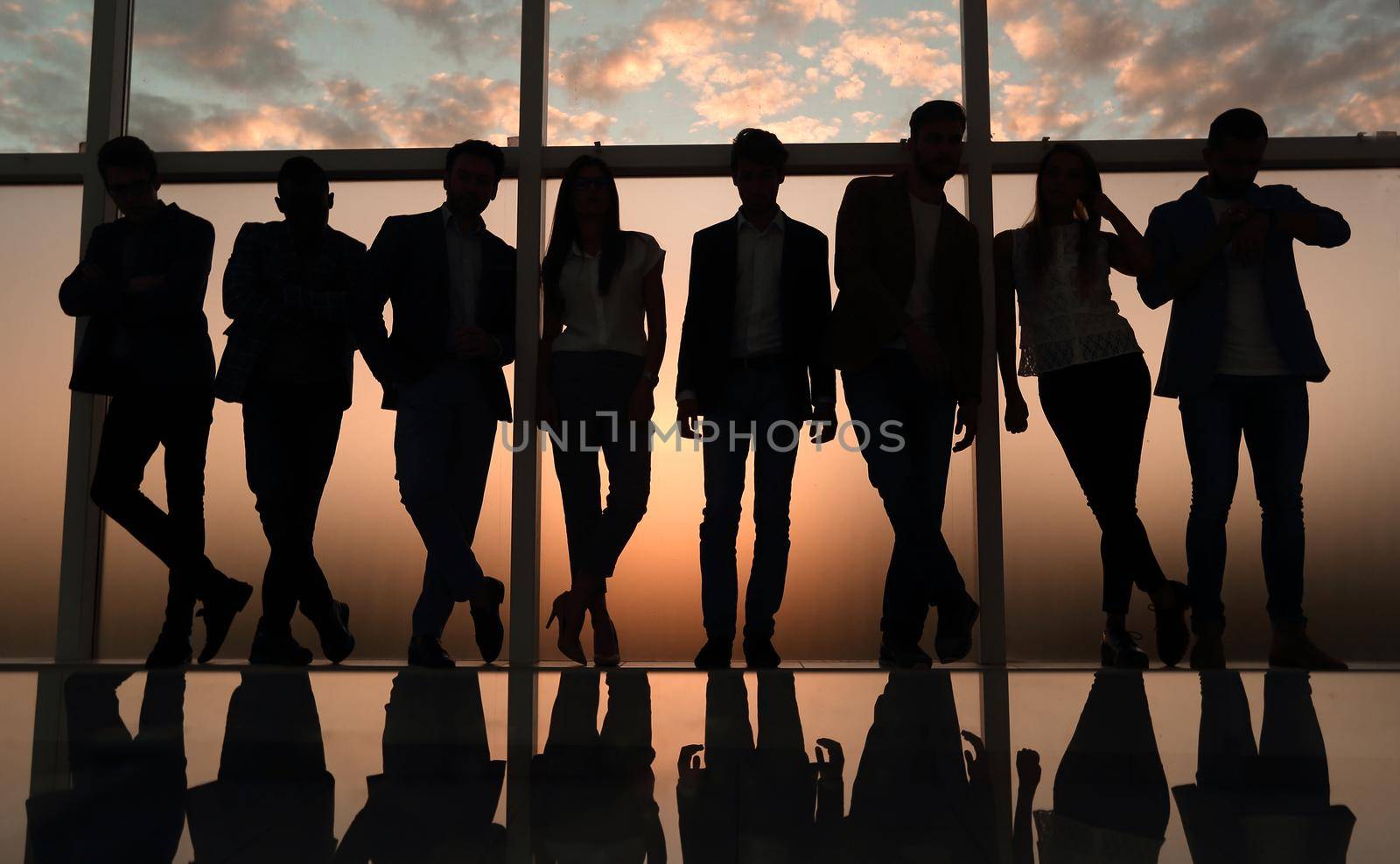 silhouette of a business team standing next to the office window. .photo with copy space