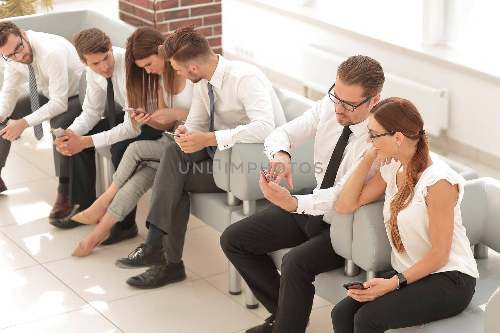 business team sitting in the lobby of the business center .business concept