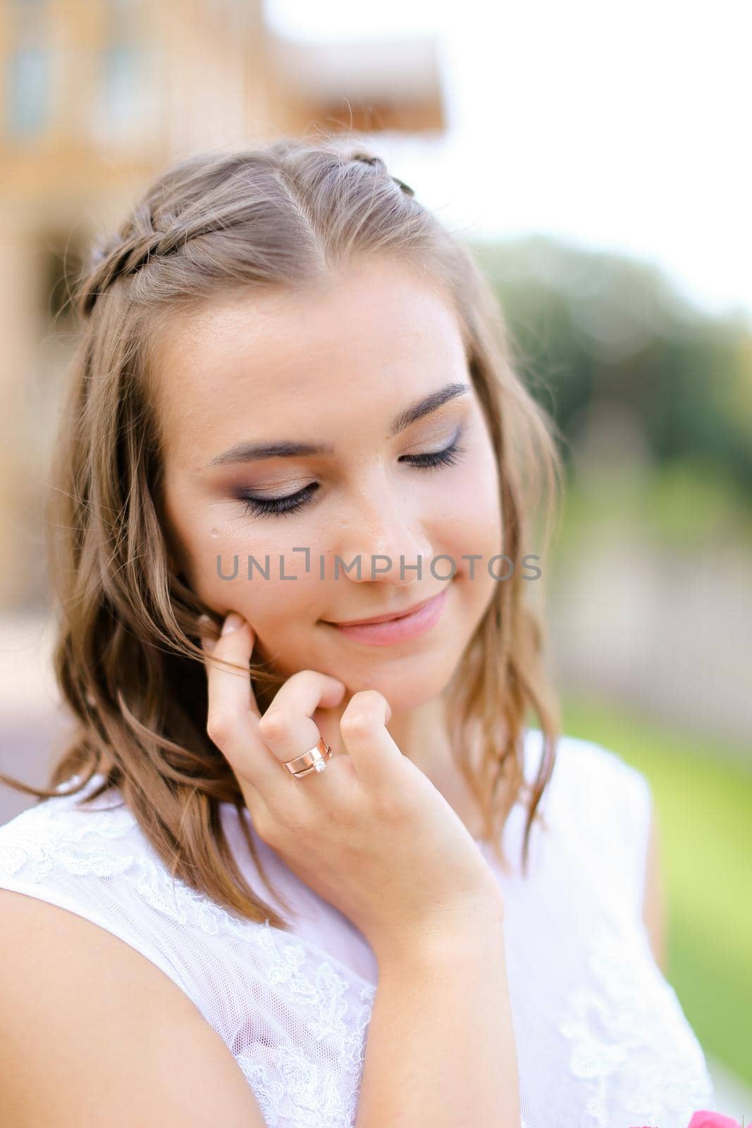 Portrait of young caucasian bride standing outdoors. Concept of bridal makeup and women beauty.