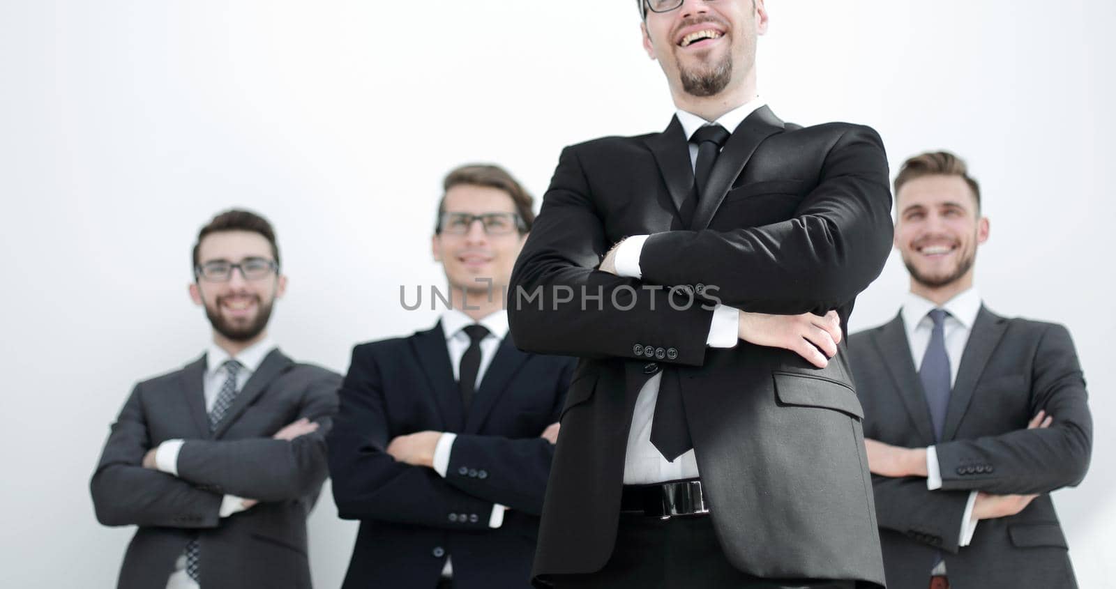 smiling business man standing in front of business team.photo with copy space