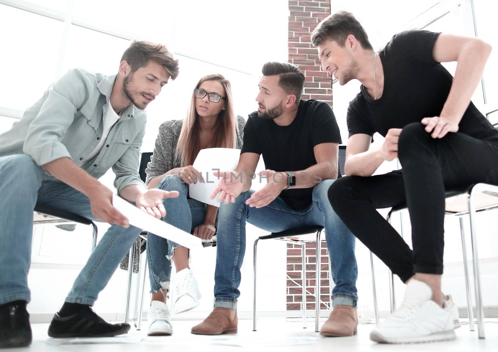 Businessman passing agreement to the business partner in conference room. Group of businessmen and businesswomen working together.