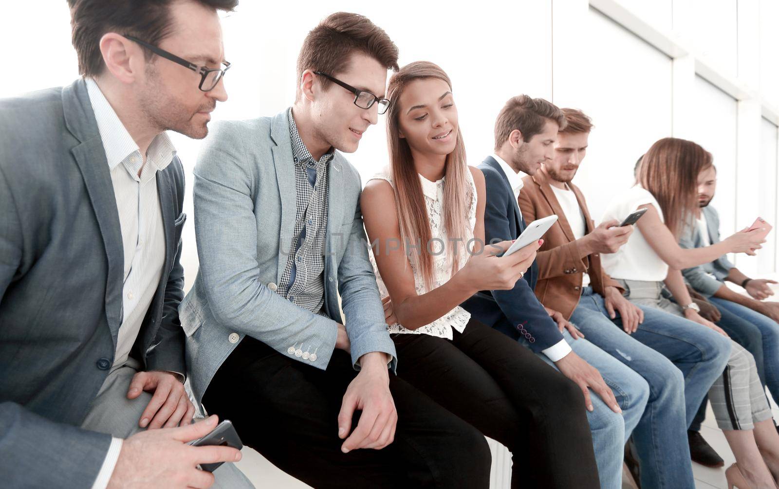 group of young people use their smartphones by asdf