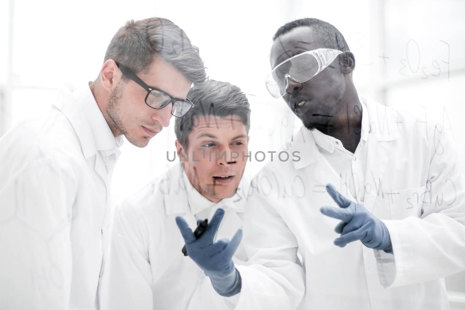 group of scientists talking in the laboratory. by asdf