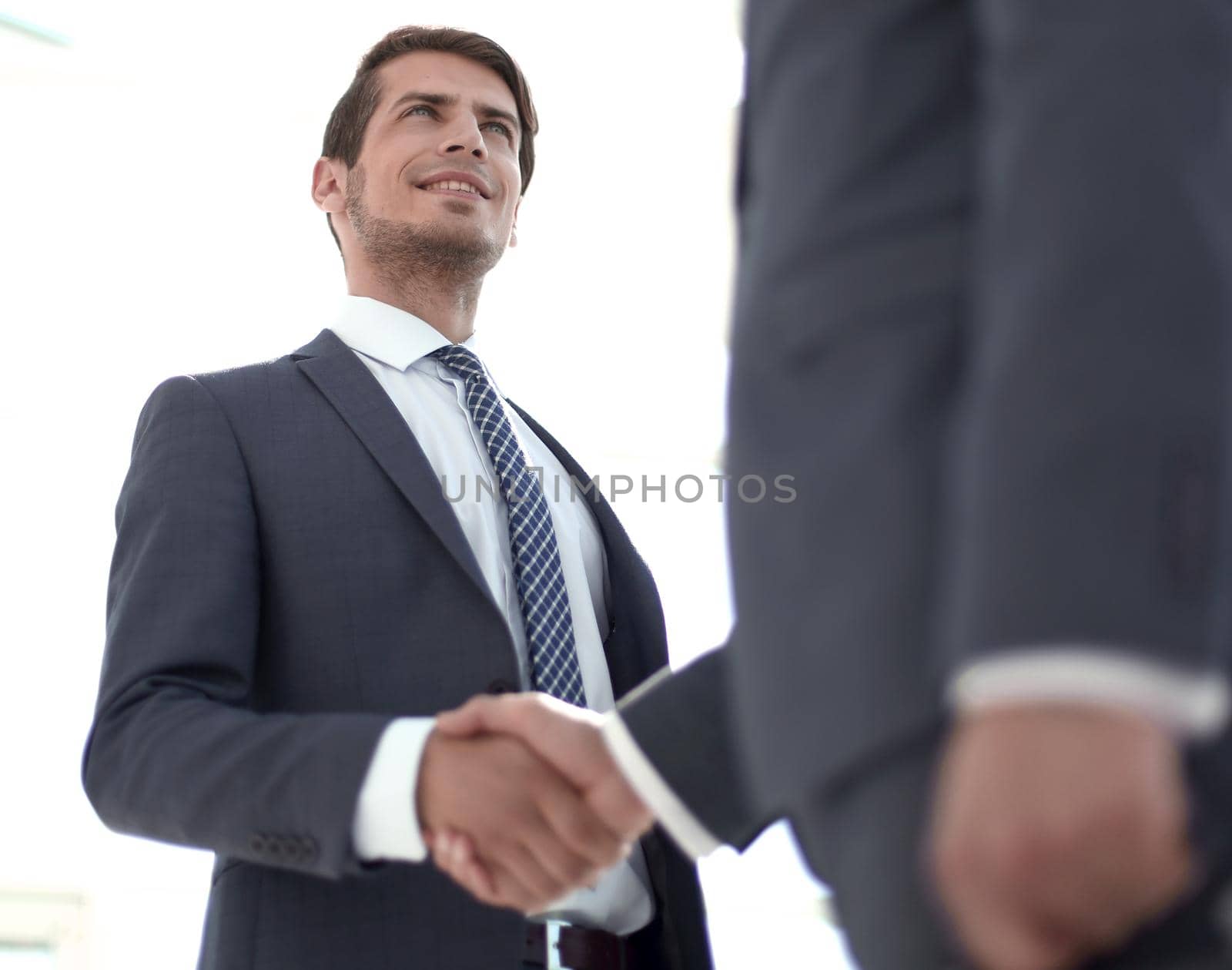 close up.businessman shaking hands with his business partner.concept of cooperation