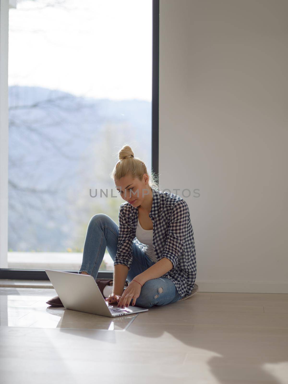 Real Woman Using laptop At Home on the floor Drinking Coffee Enjoying Relaxing