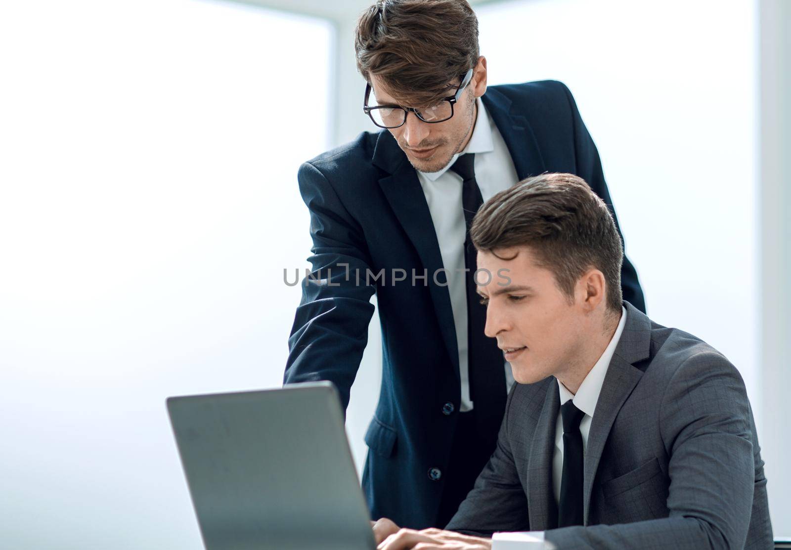 two businessmen working in the office. by asdf