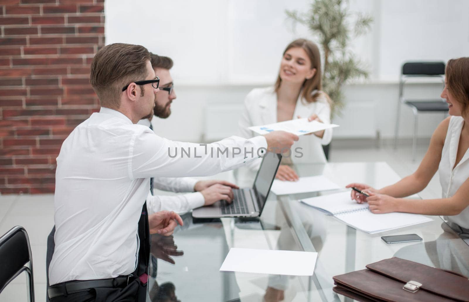 employees discussing business documents.office weekdays