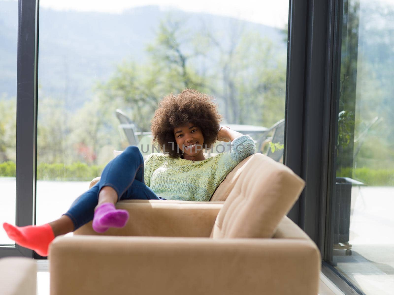 Young african american woman at home relaxing in her luxury lliving room reading a digital tablet  surf internet and work