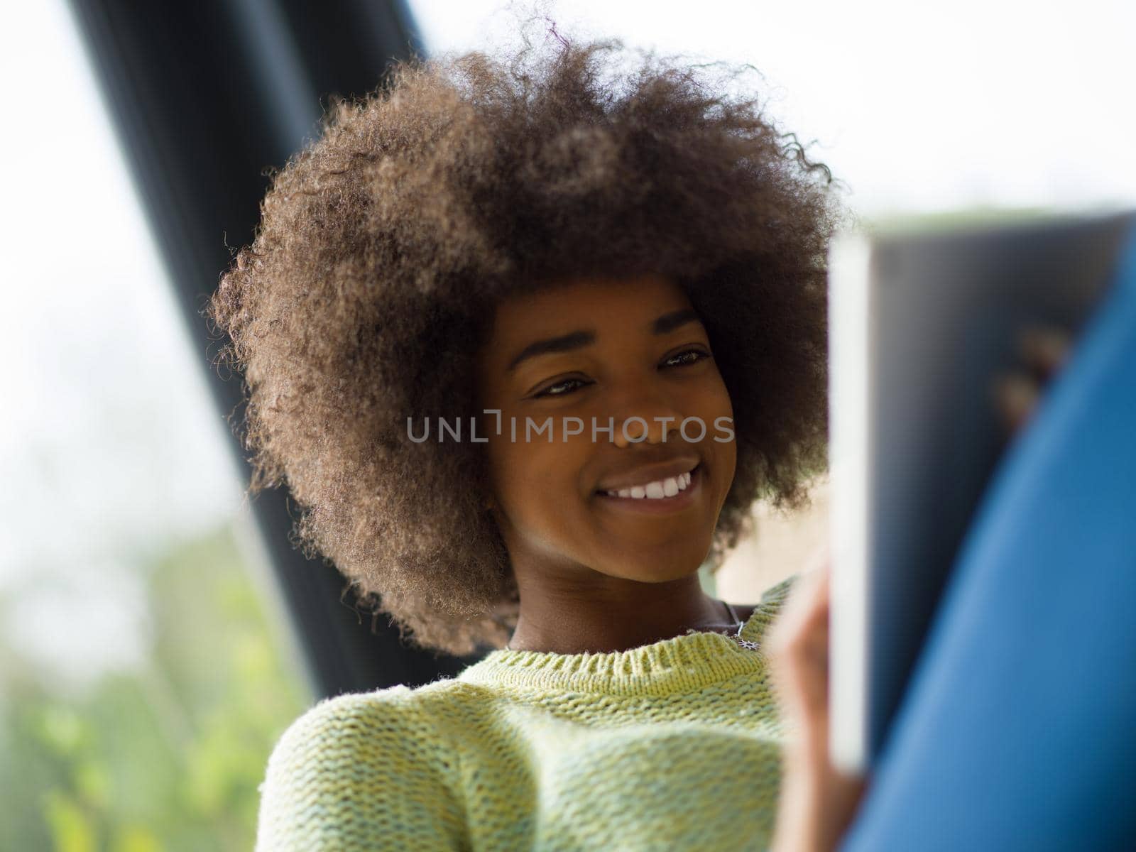 Young african american woman at home relaxing in her luxury lliving room reading a digital tablet  surf internet and work