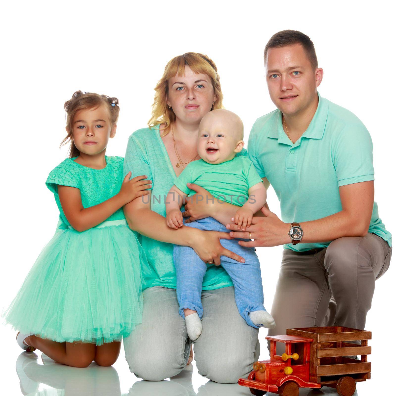 Happy family with young children. The concept of family happiness and development of children. Isolated on white background.