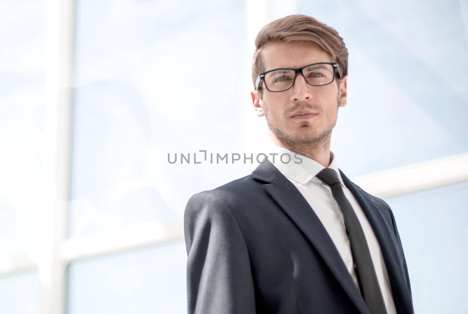 confident businessman on background of office window.photo with copy space