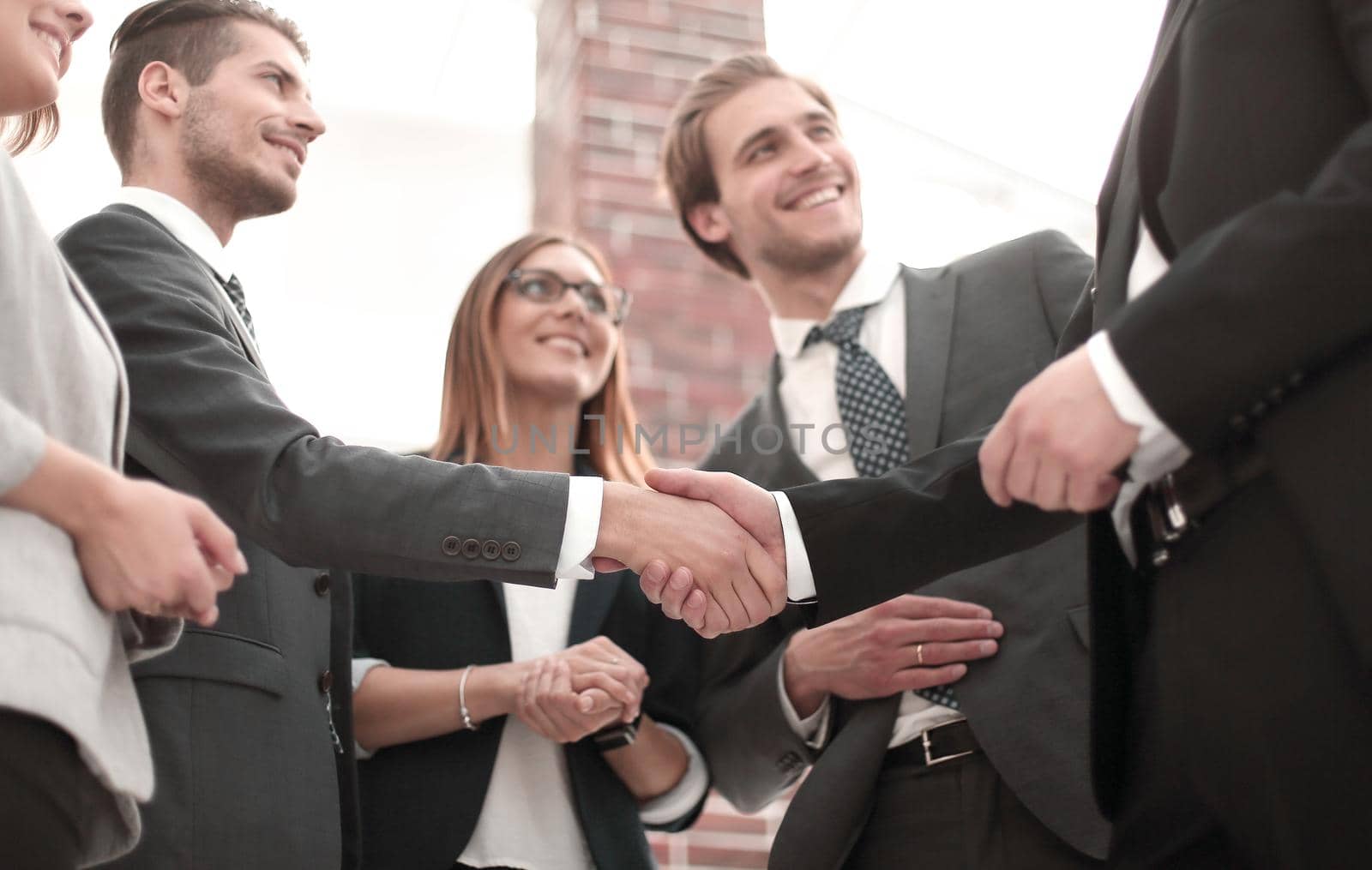Happy businesswomen shaking hands in office