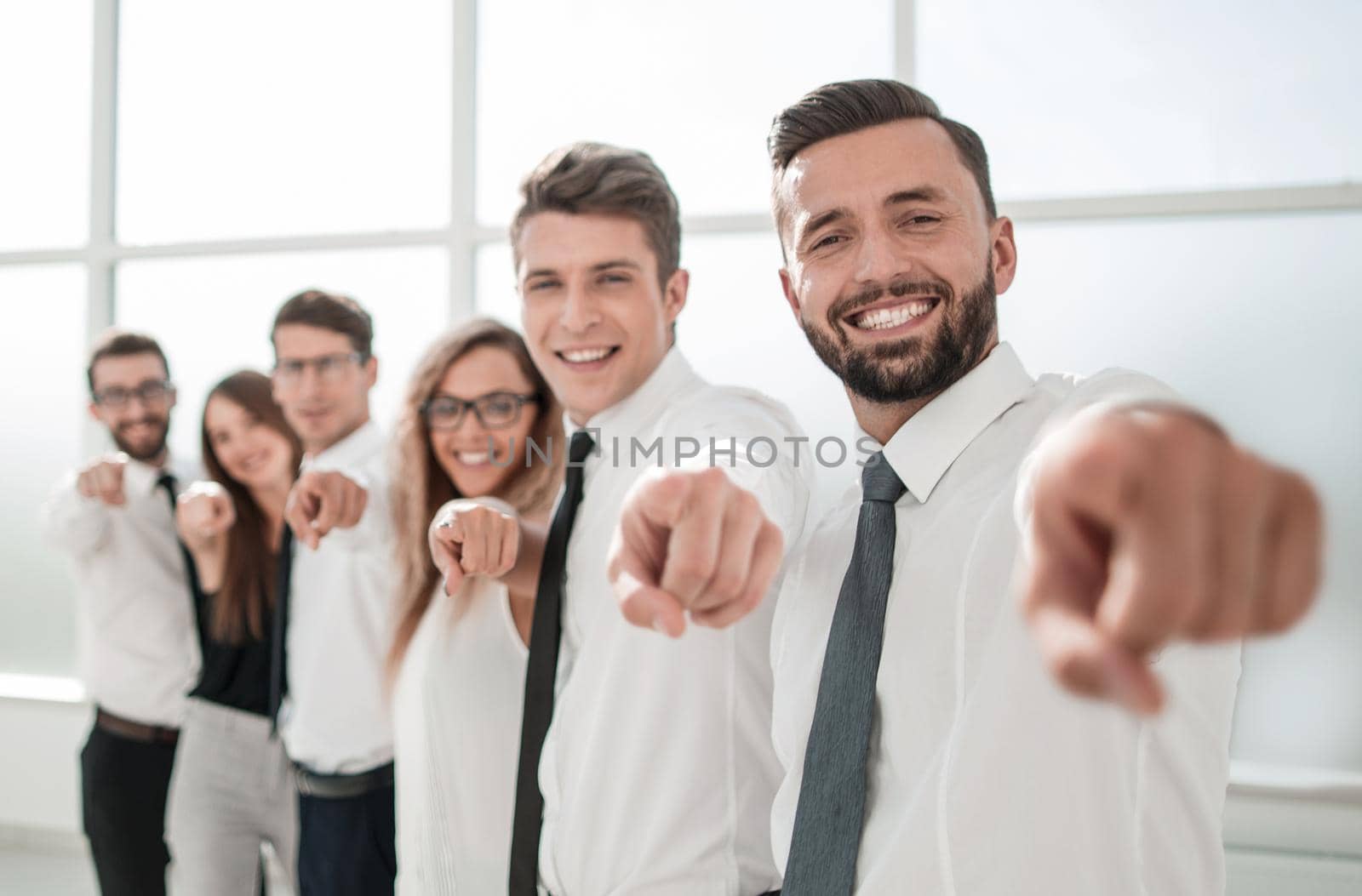 business team standing in new office and pointing forward.photo with copy space