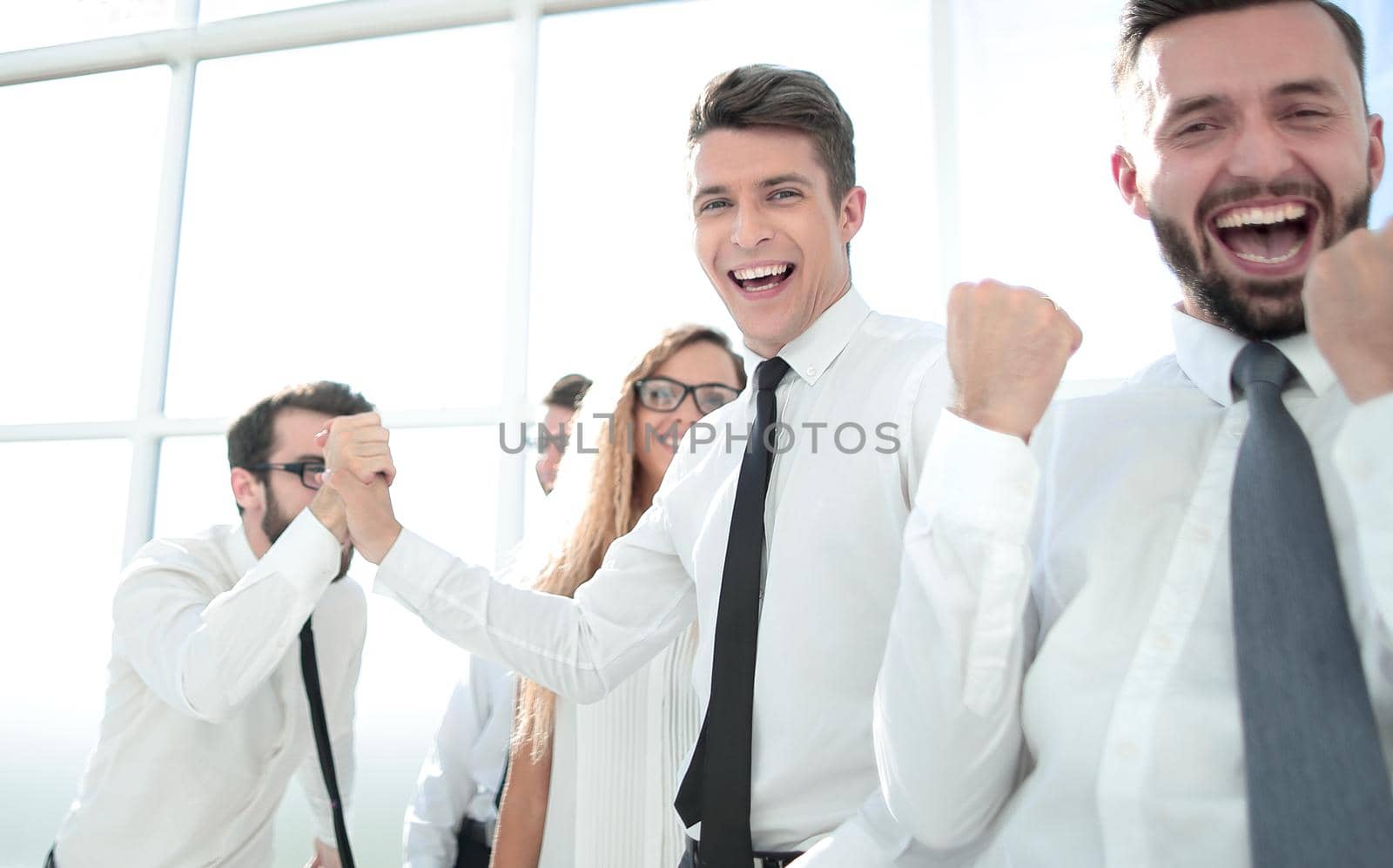happy employees standing in spacious office.photo with copy space