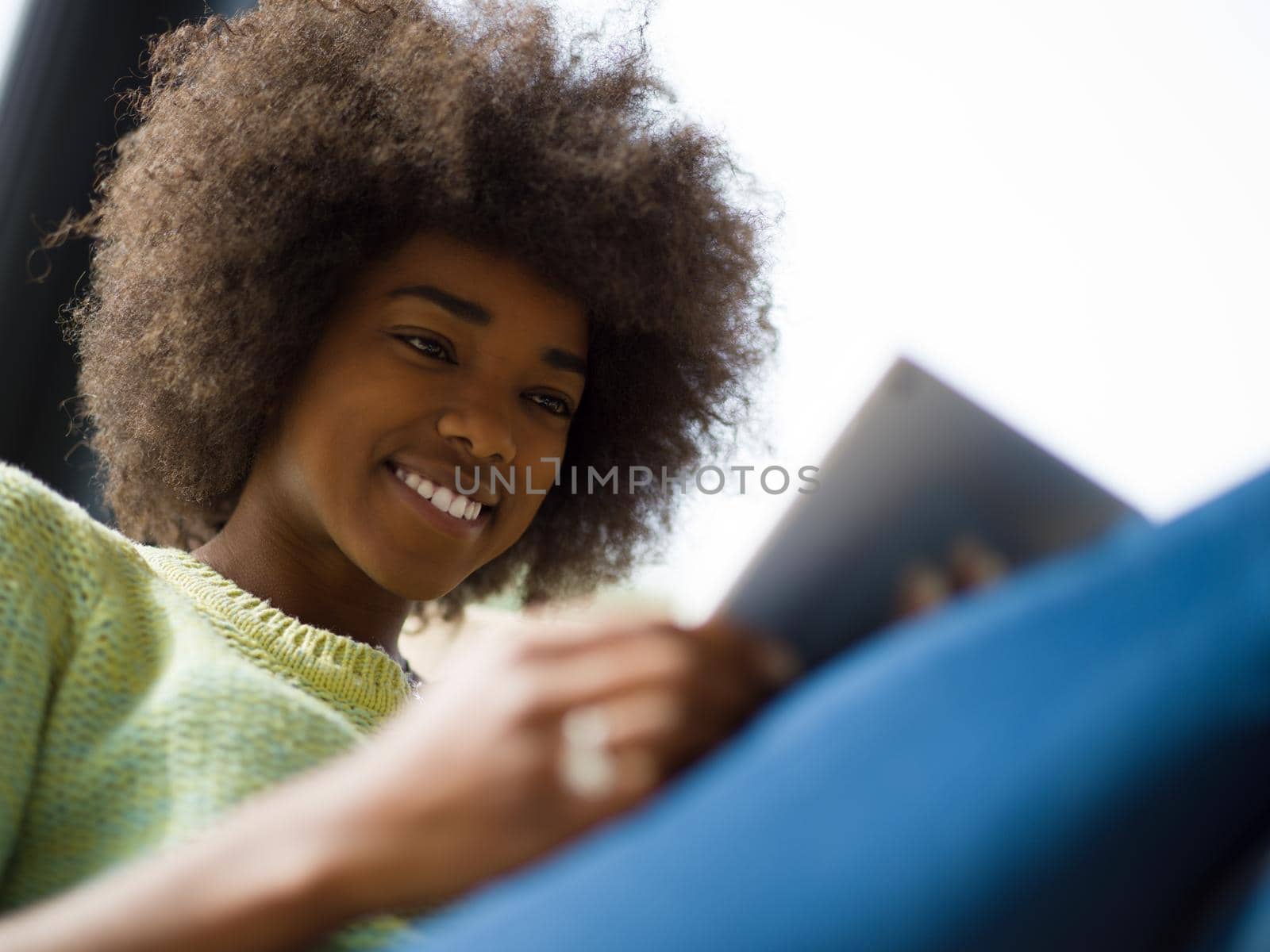 Young african american woman at home relaxing in her luxury lliving room reading a digital tablet  surf internet and work