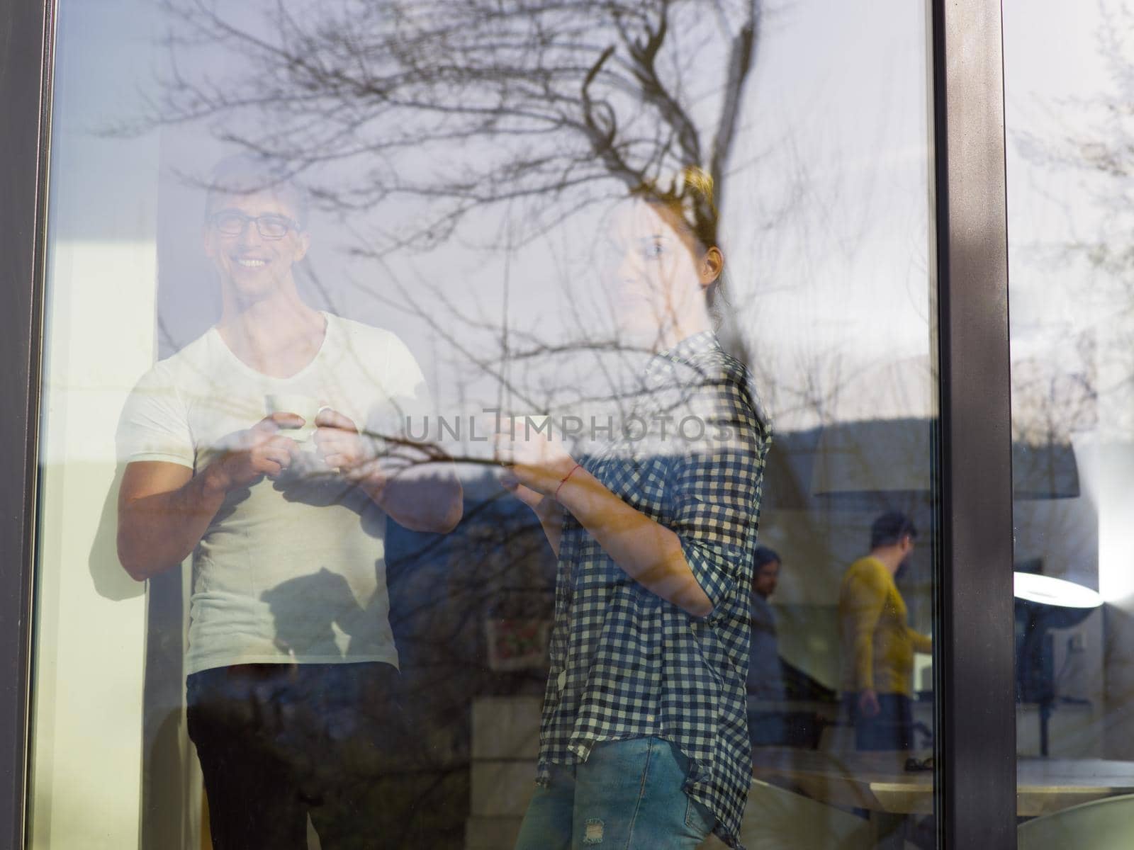 romantic happy young couple enjoying morning coffee by the window in their luxury home