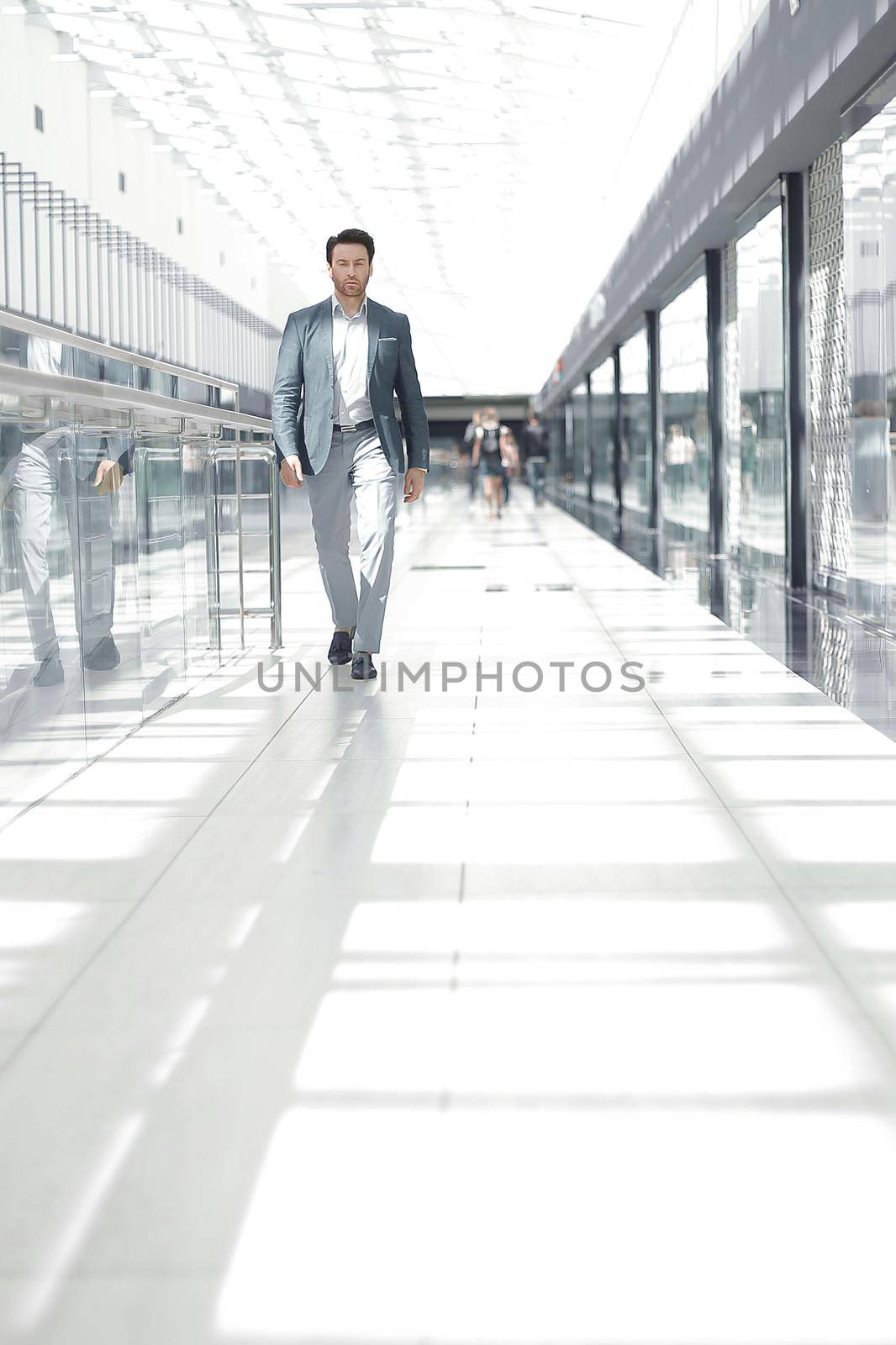 businessman walking in the airport building. the concept of business travel.