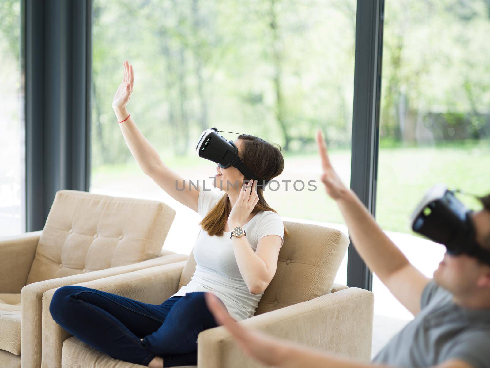 Couple using virtual reality headset in living room at home  people playing game with new trends technology