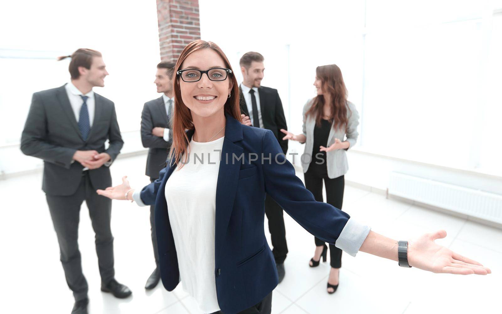 smiling business woman with open hands gesture at the office