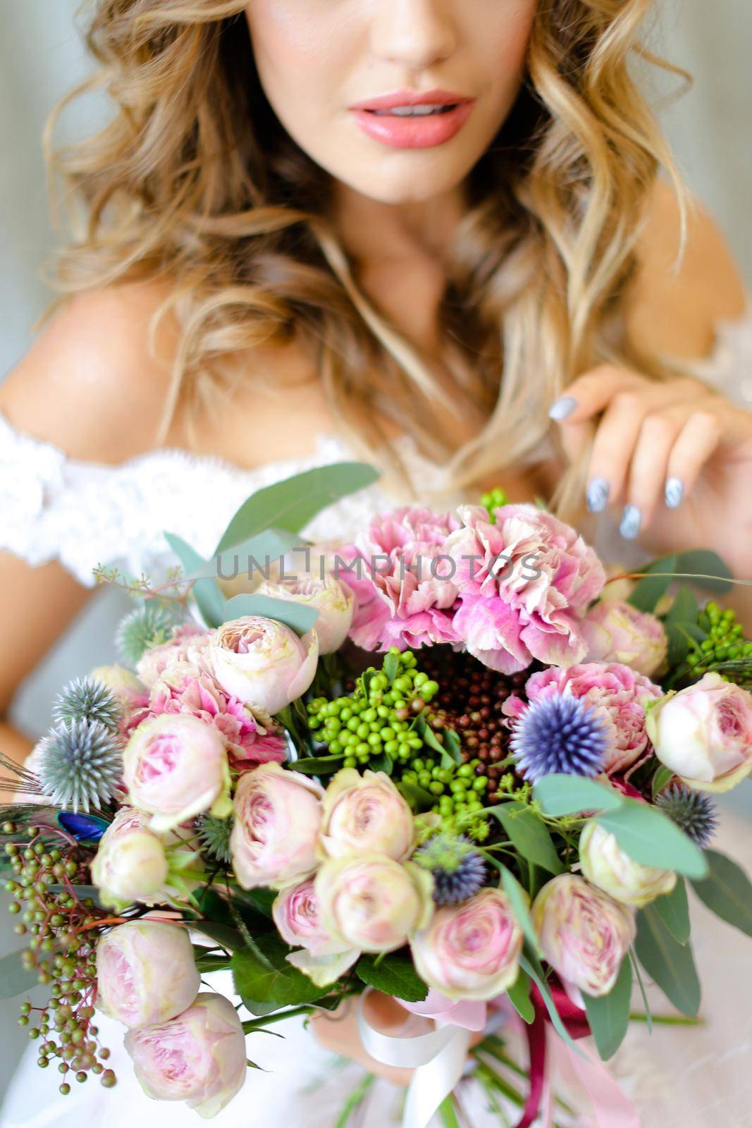 Young european bride wearing white dress with bouquet at photo studio. by sisterspro