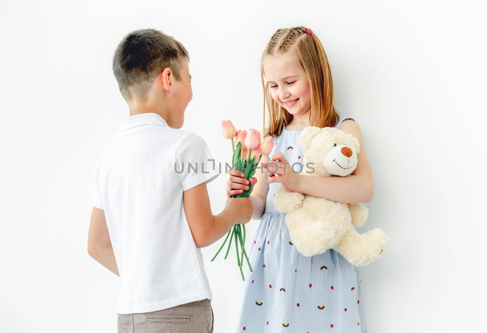 Cute little boy giving present to smiling little girl