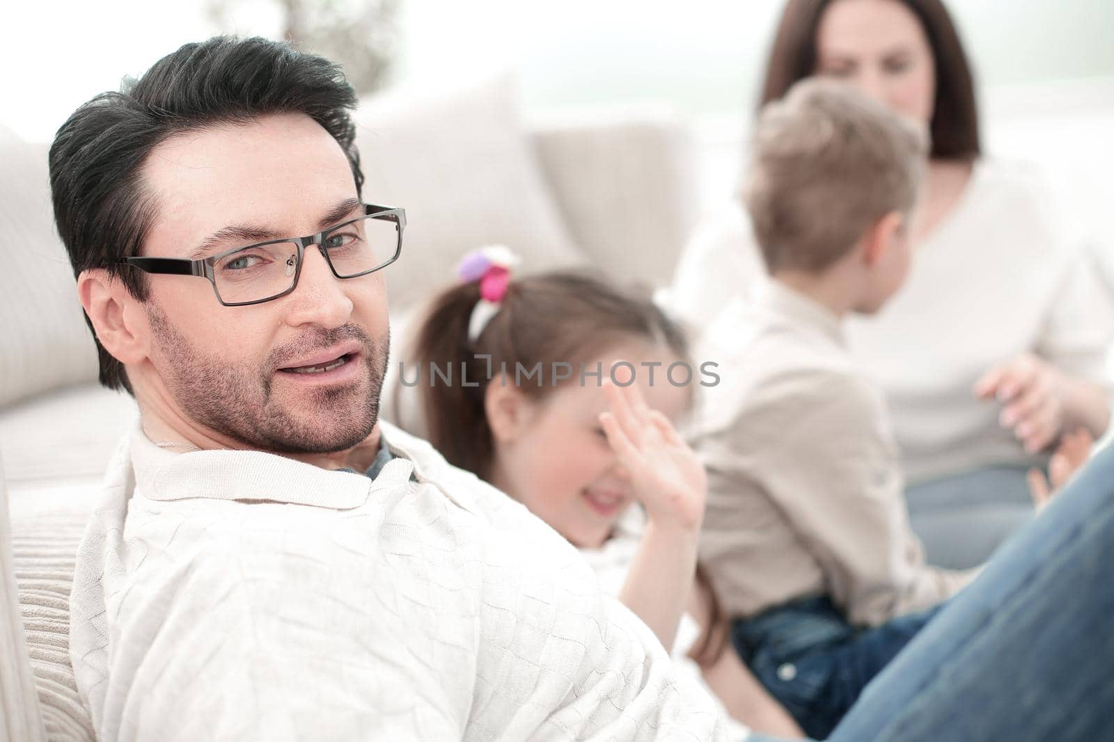 close up.parents play with their children sitting on the couch by asdf