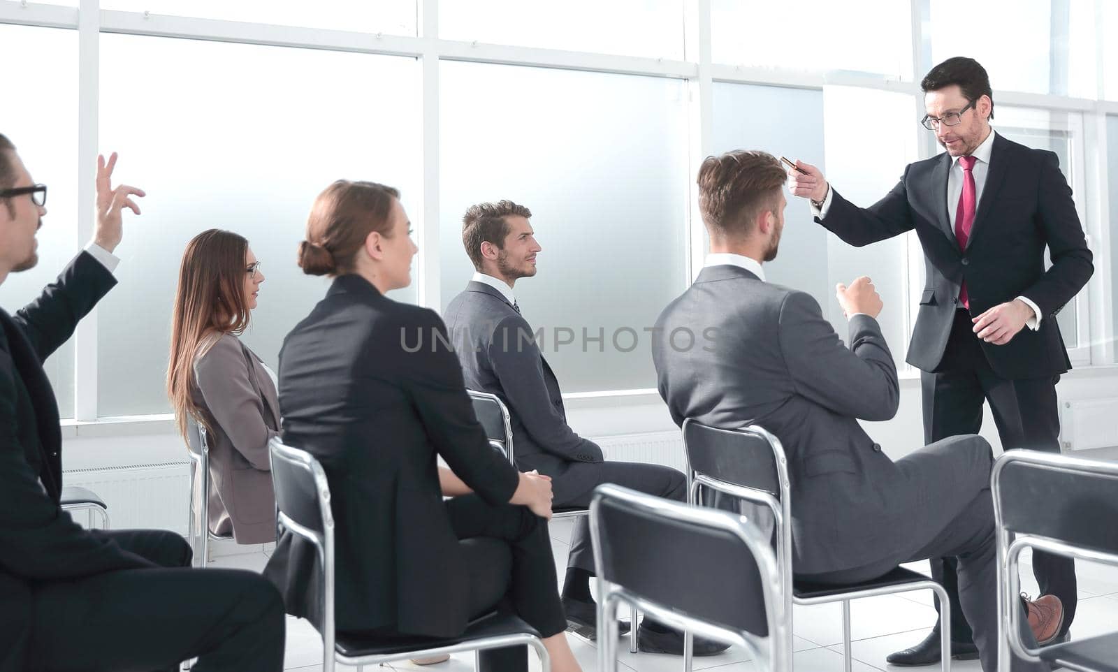 Business people Raising there Hand Up at a Conference to answer a question