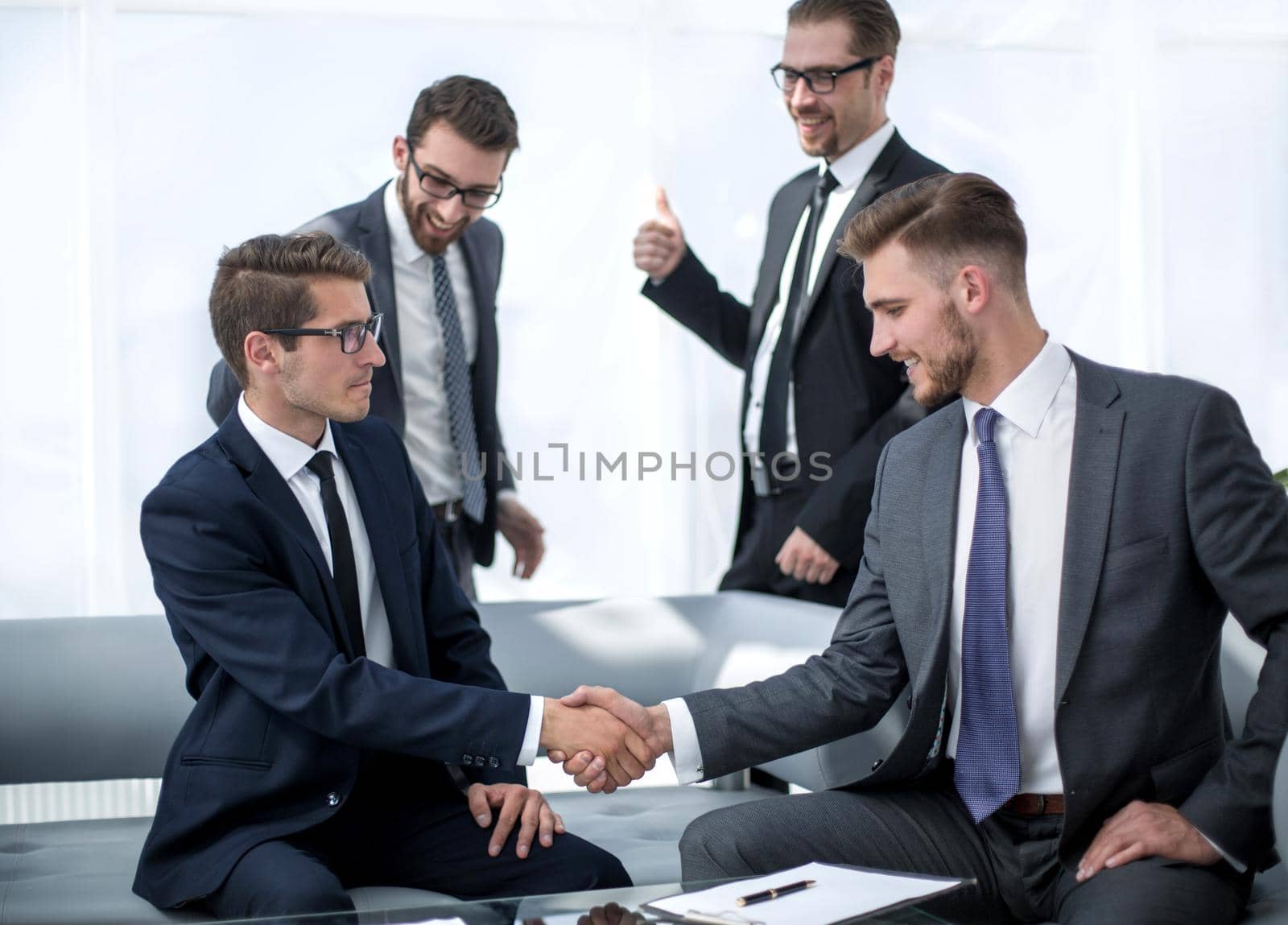smiling business partners shaking hands.the concept of cooperation