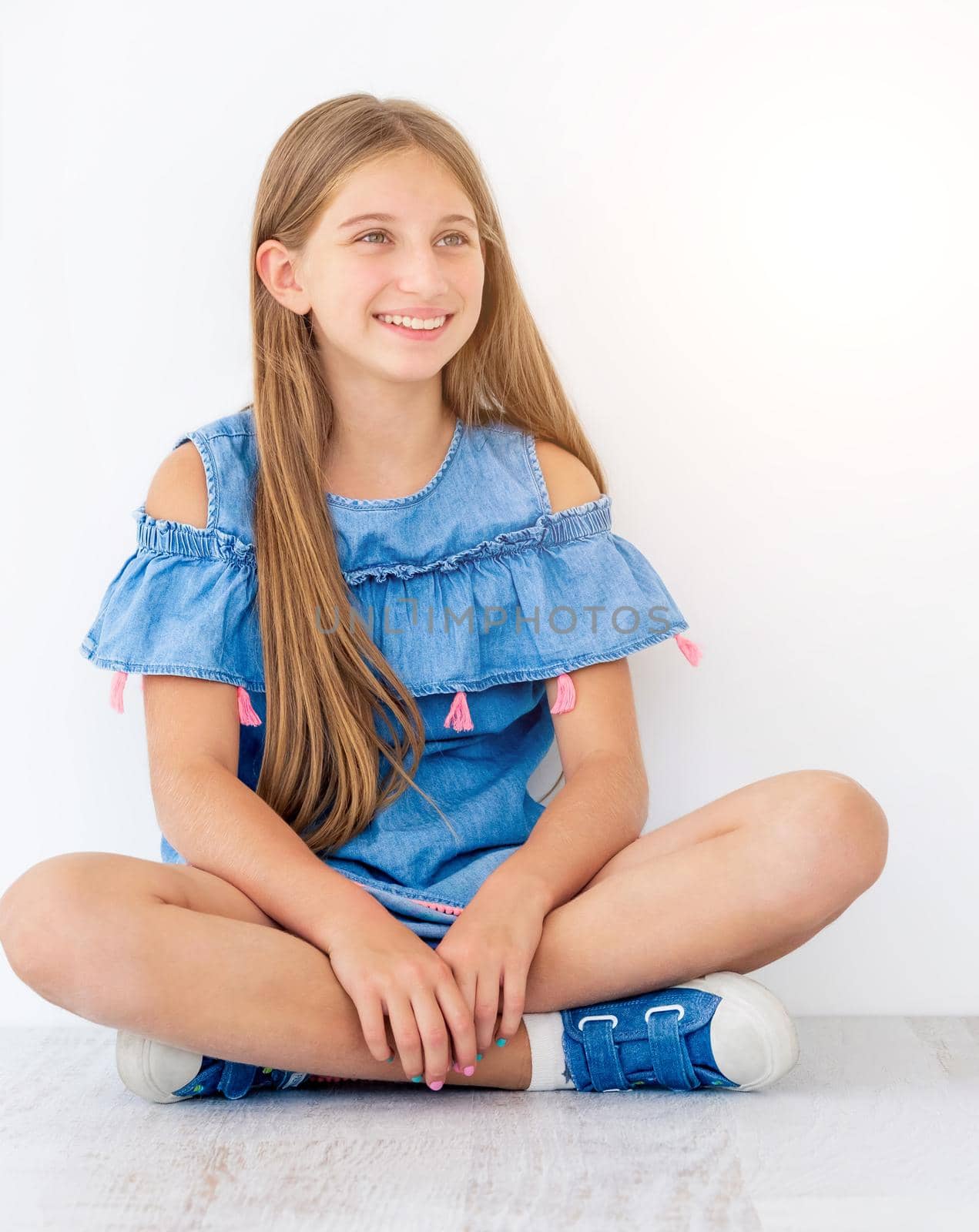 Pretty long haired girl sitting in light room