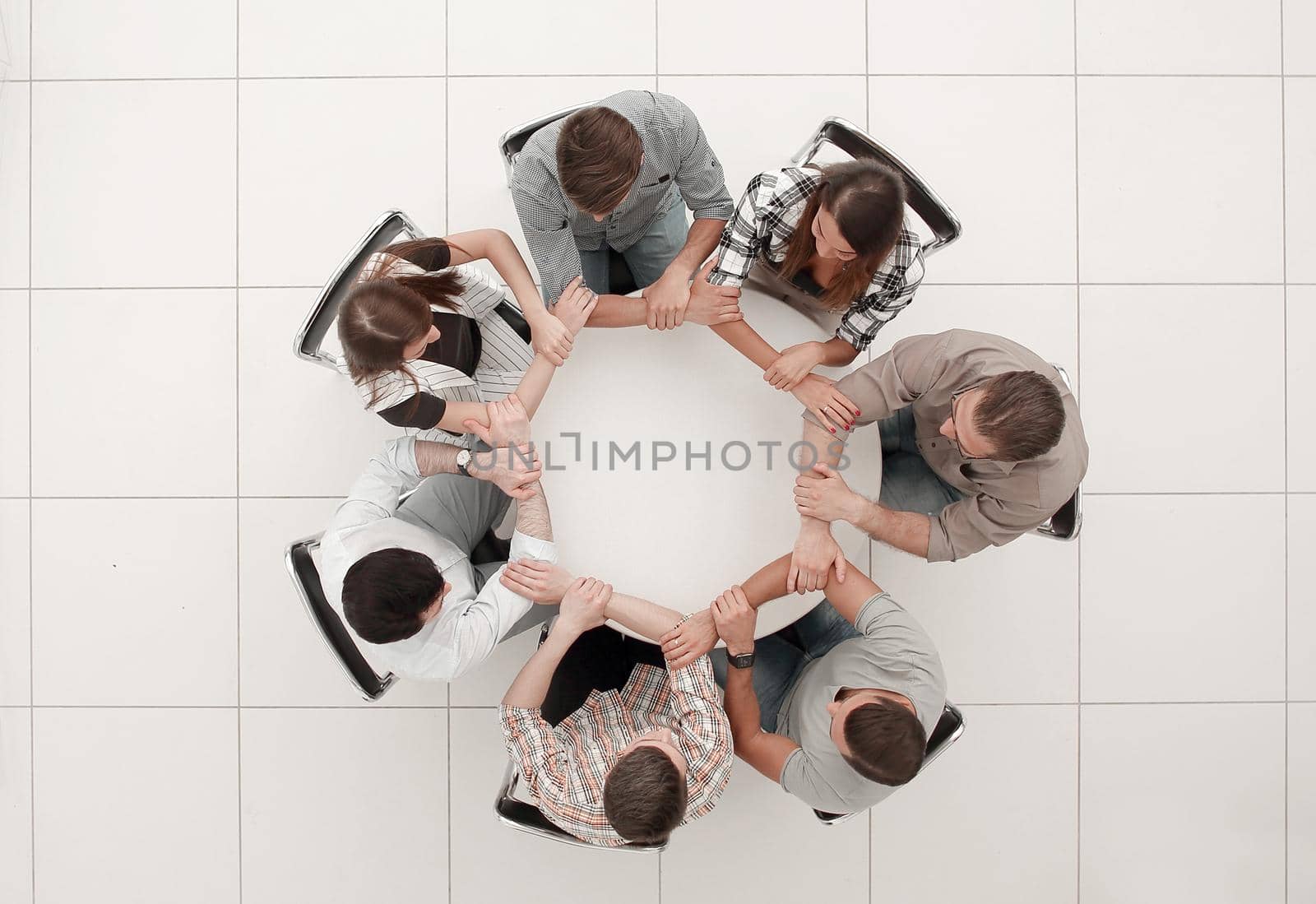 top view.The business team hold hands, forming a circle.the concept of unity